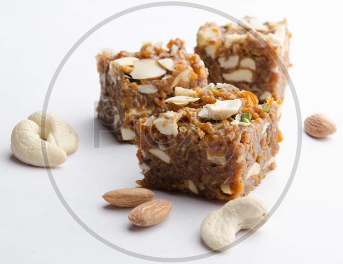 Indian Traditional Sweet  or Savory Barfi Or   Kova  With Dry Nuts Toppings  over an Isolated White Background