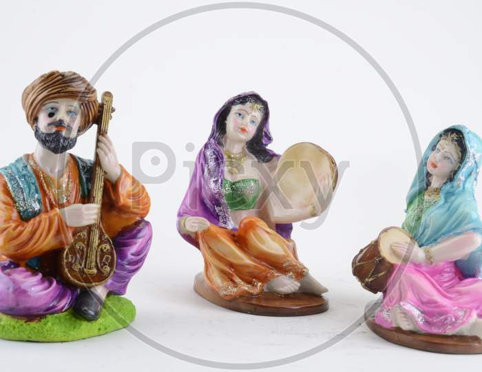 Action Figures Of Indian Traditional  Musicians Playing Instruments Over An Isolated White Background