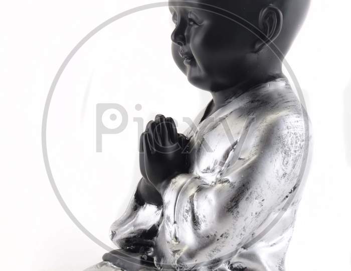 Chinese Boy Action Figure With Namaste Gesture Or Welcoming Gesture Over An Isolated White background