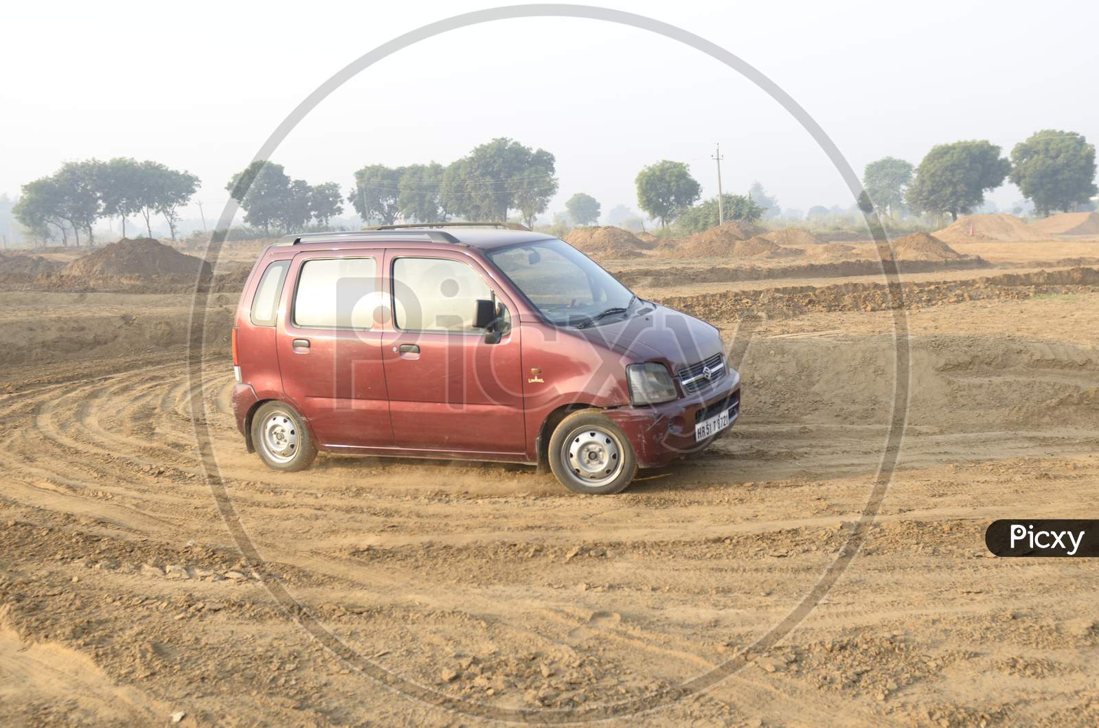 Maruti Suzuki Wagon R moving along the dirt road