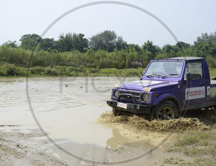 A Jeep moving in the water during Rally Race