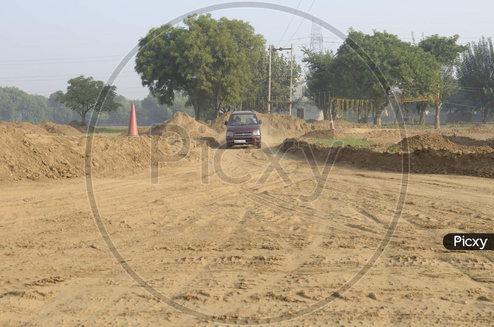 View of A Maruti Suzuki Wagon R Car moving through the dirt