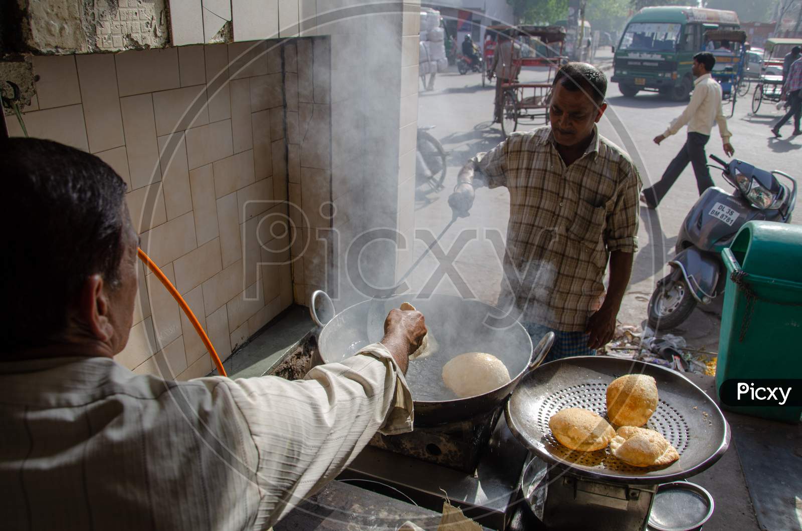 Street Food Vendor Making Poori Or Bature At a Street Food Stall