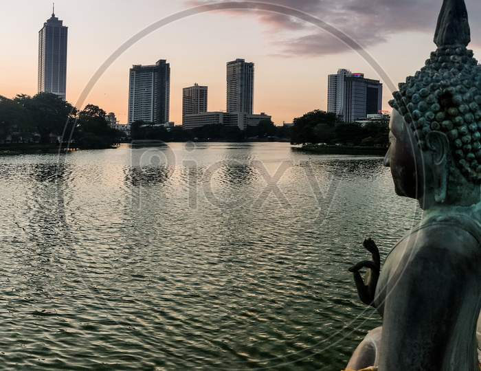 SriLanka City skyline at sunset with Buddha Statue