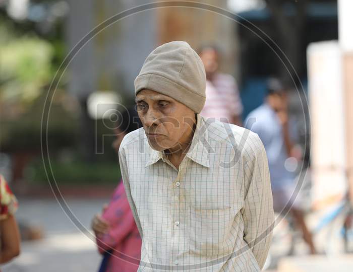 An Elderly Man Wearing a Monkey Cap
