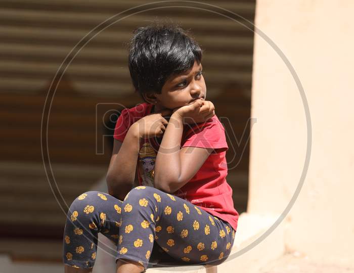 Indian Girl Child Sitting At a Road Side