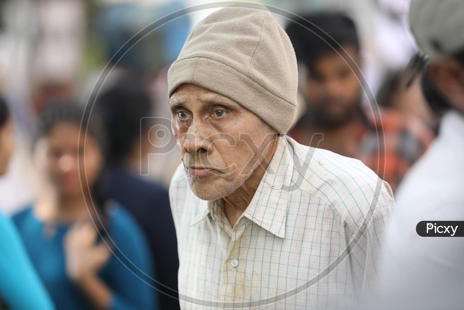 An Elderly Man Wearing a Monkey Cap