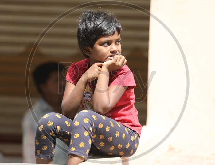 Indian Girl Child Sitting At a Road Side