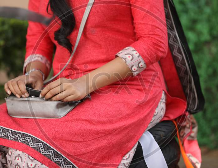 Indian Girl With Hands on a Hand  Bag
