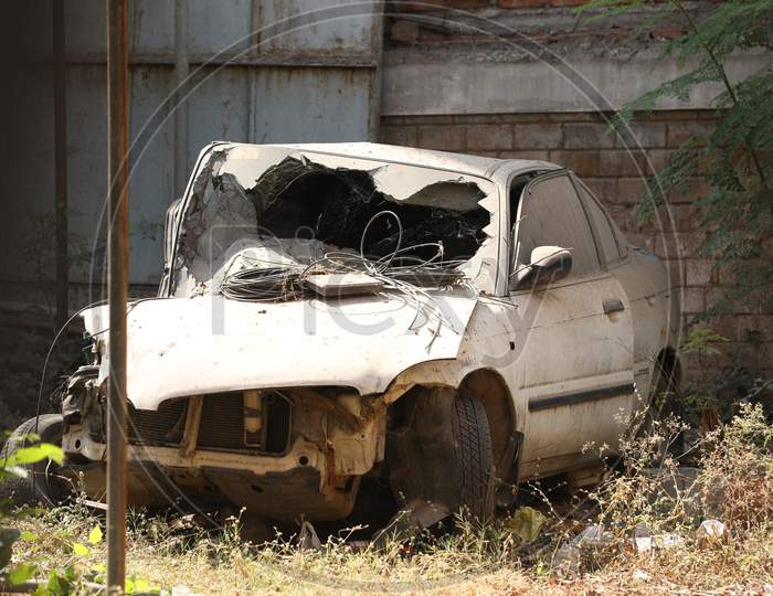 An Old Deceased Car Or Scrap Car At an Shed