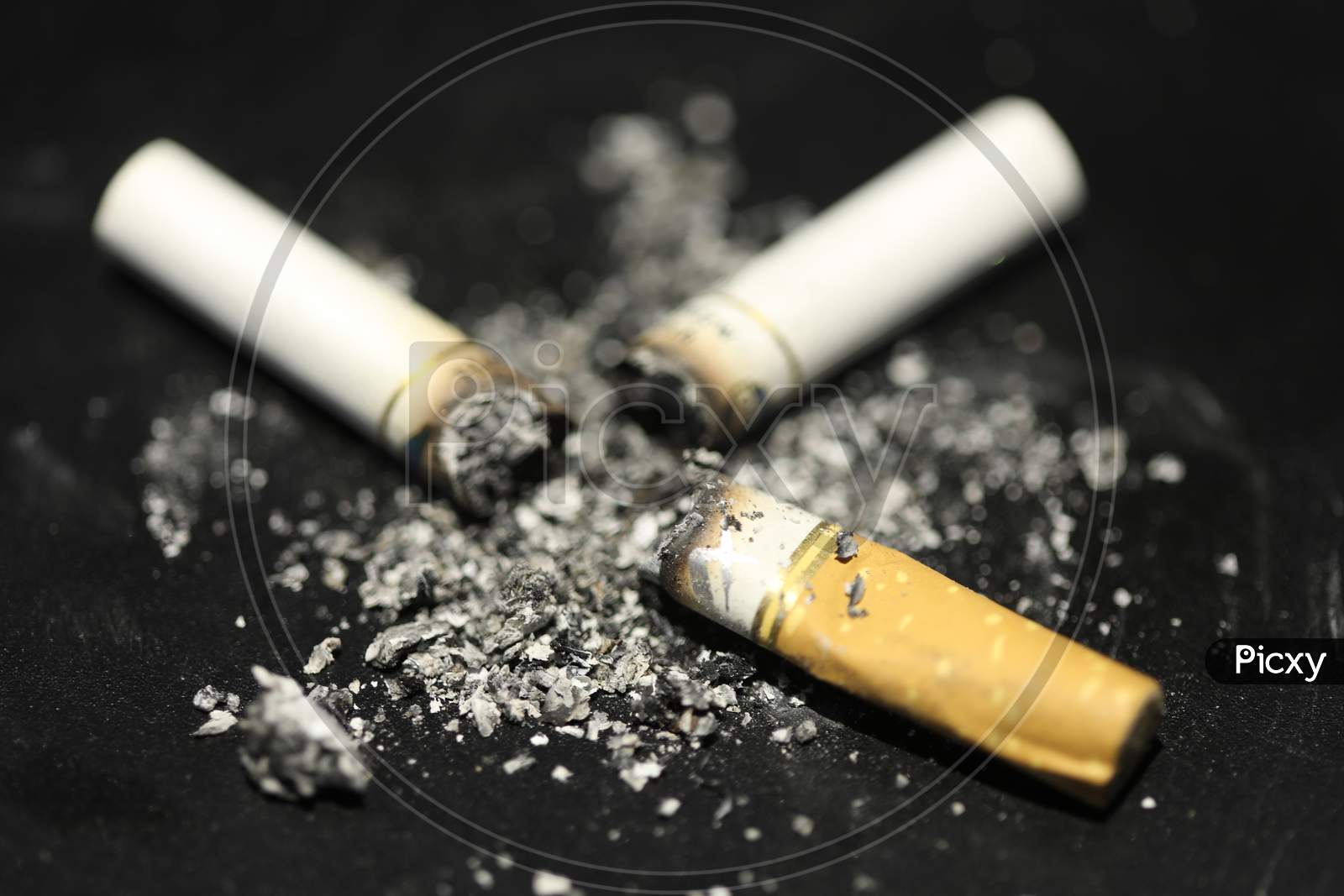 Cigarette Bud With Ash Over an Isolated Black Background , Smoking Kills  And Anti Smoking Concept