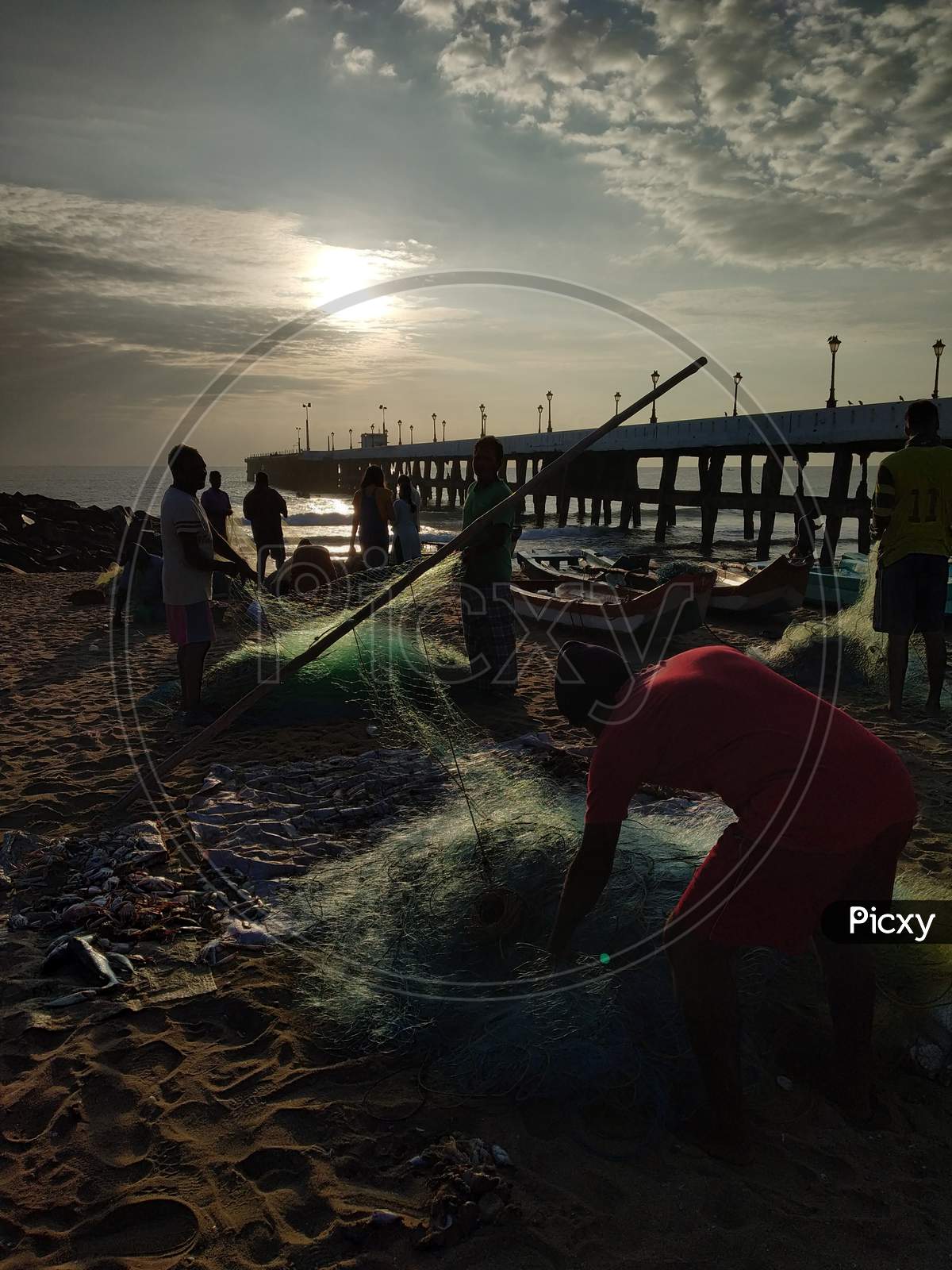 Silhouette Of Fisherman With Fishing Nets at Pondicherry Beach