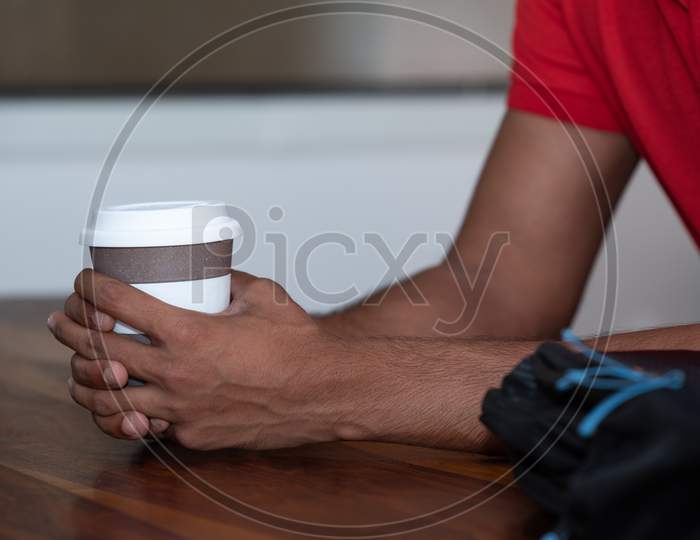 Indian Male Student With a Coffee Cup , Closeup Of Hands