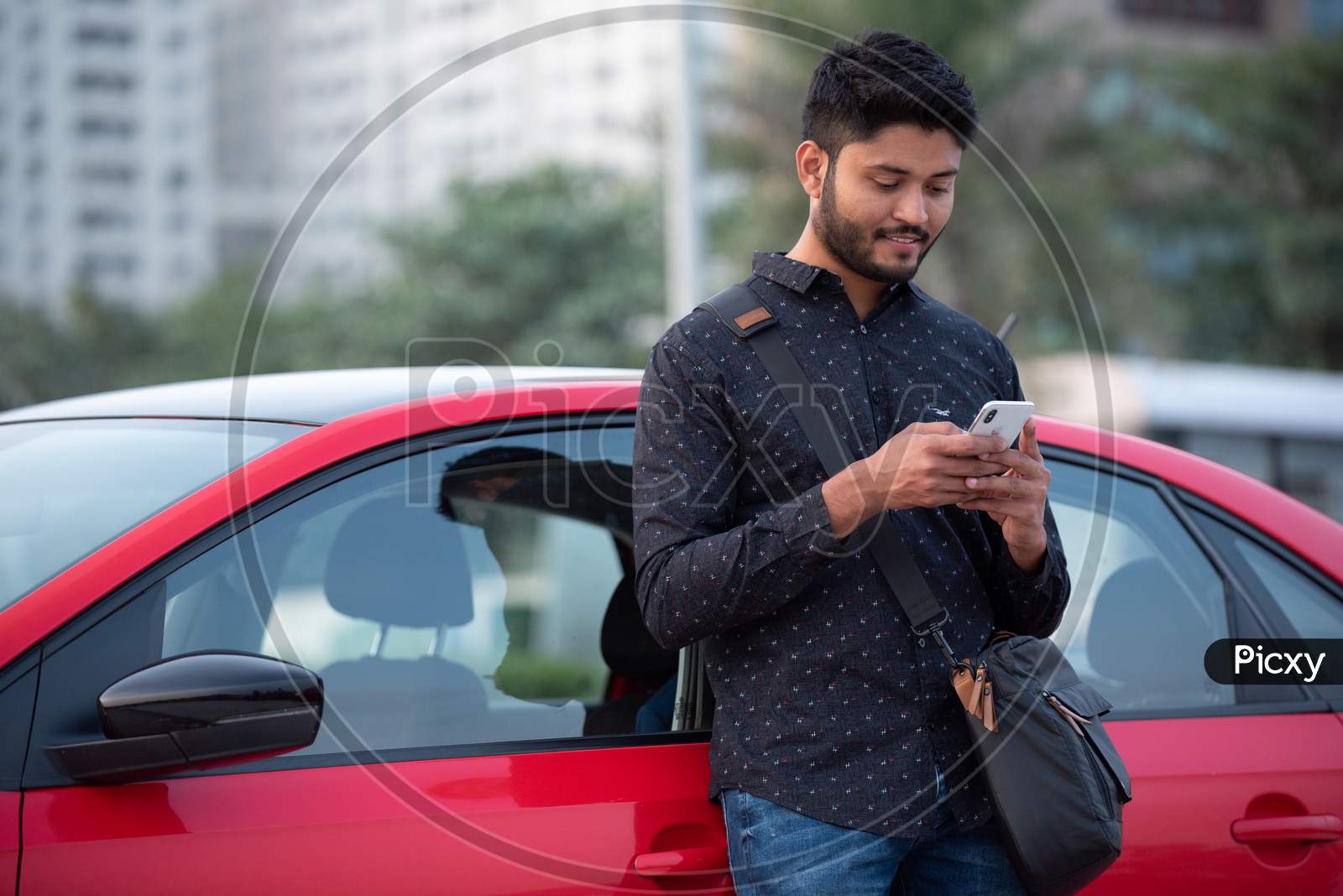 Indian Student Using Mobile By Standing Near a Car