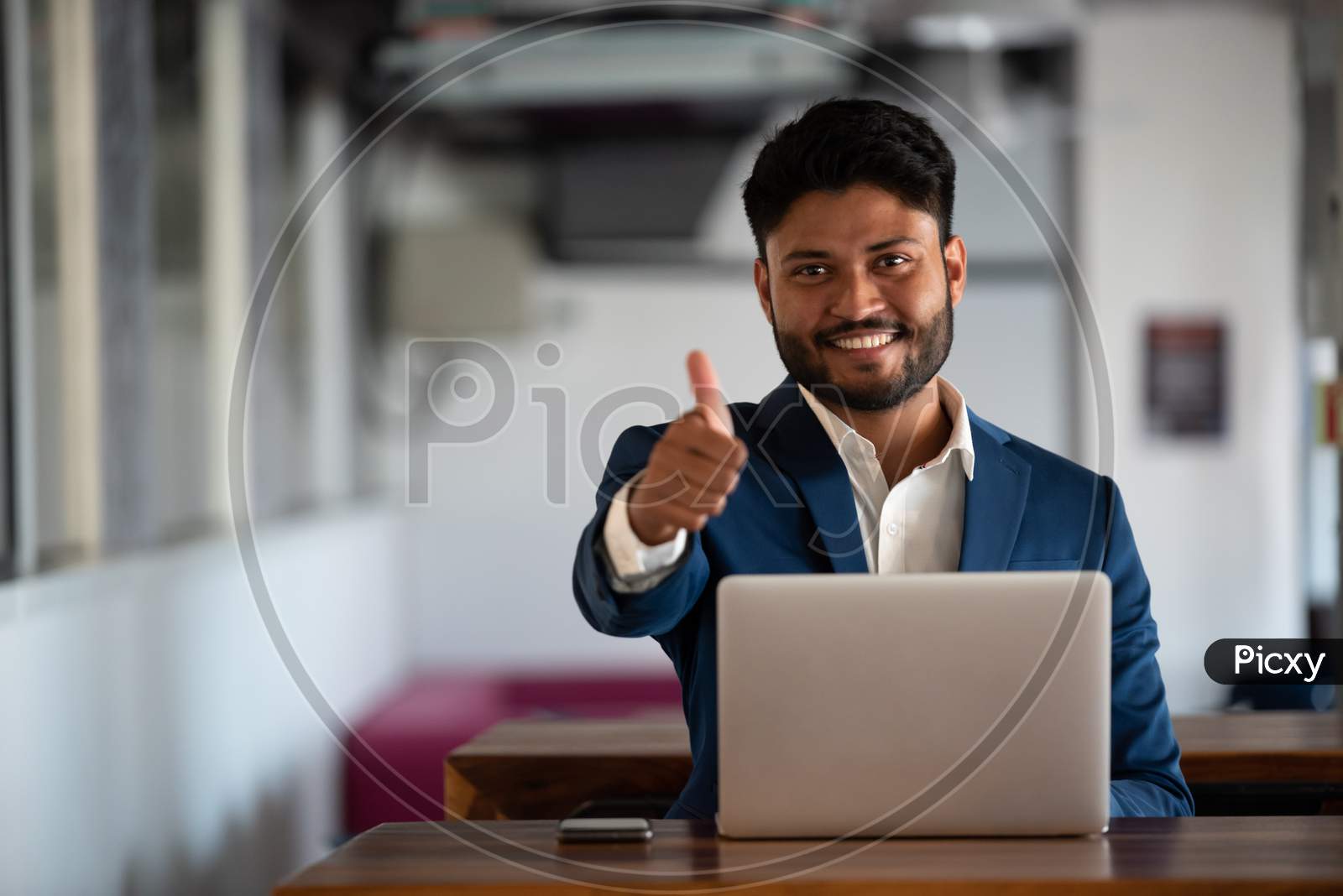 Indian Successful  Businessman With Smile Face Using  Laptop at an Office