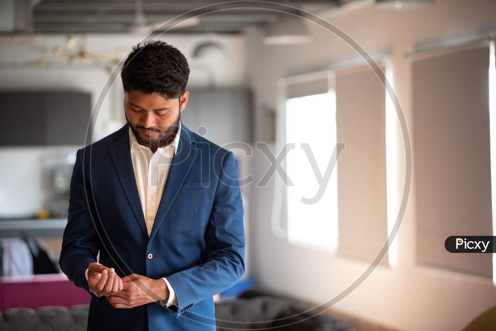 Indian Businessman  In Suite At An Office Backdrop