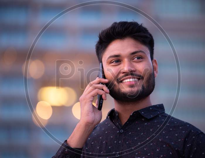 Young Indian Businessman With Smile Face  Speaking in Mobile