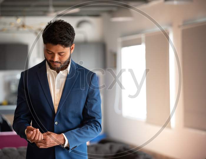 Indian Businessman  In Suite At An Office Backdrop