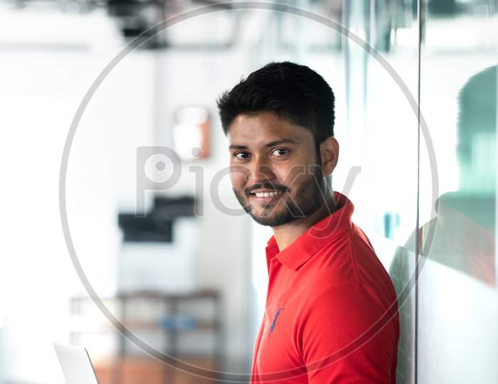 Indian Male Student Using Laptop With Smile Face