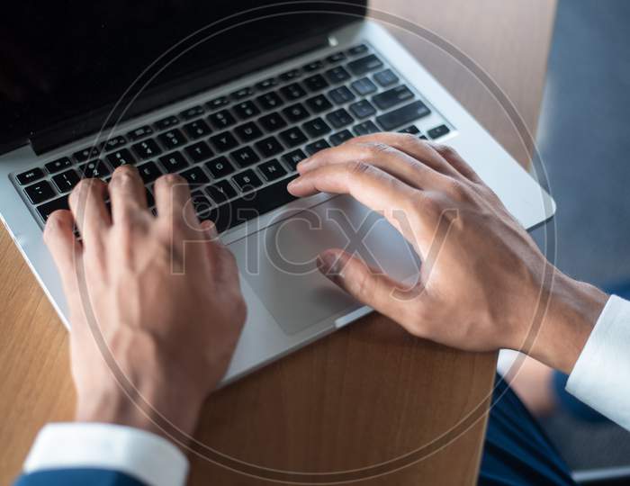 Indian Businessman Using Laptop At an Office Desk  Hands Closeup