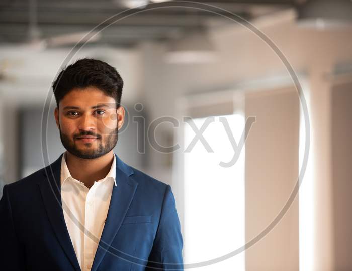 Indian Businessman With Smile Face Standing at an Office in Suite