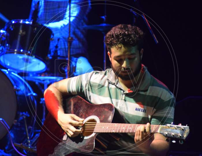 A Guitarist  Performing on Stage At a College Event or Live In Concert