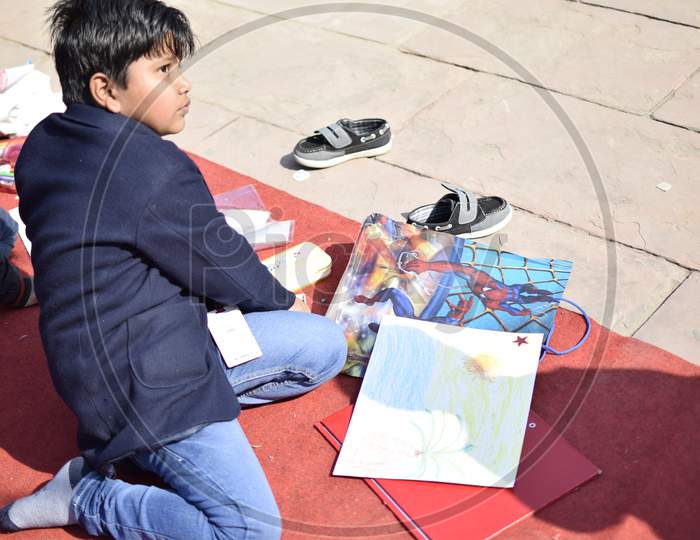 Indian school boy painting a sketch
