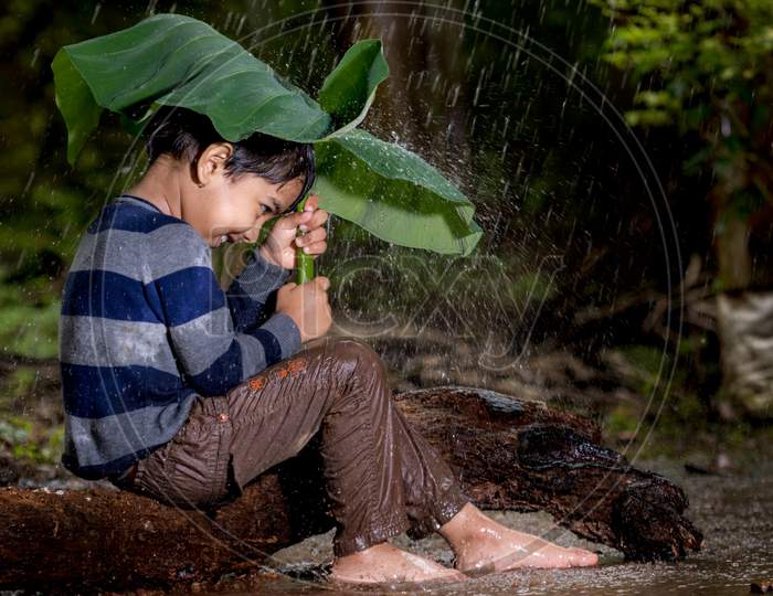A boy enjoying rain in Kerala