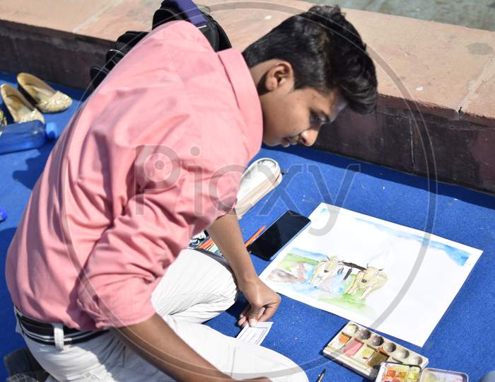 Indian School boy painting cows
