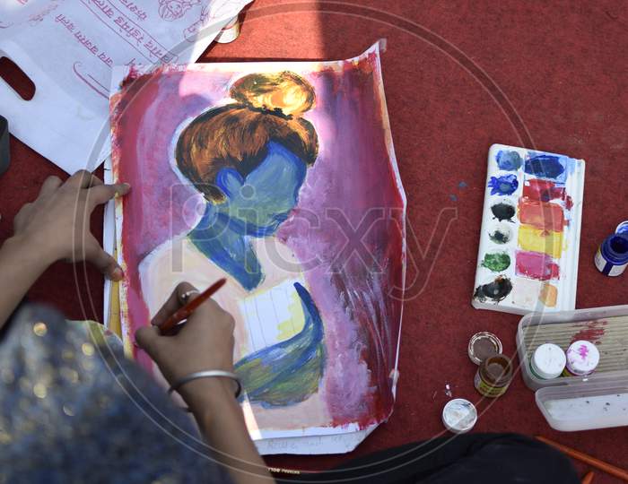 Indian School girl color sketching a girl with bun