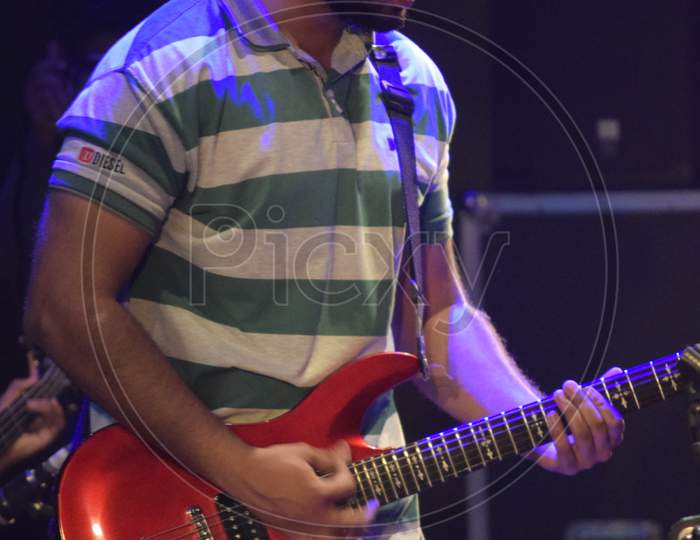 A Guitarist  Performing on Stage At a College Event or Live In Concert