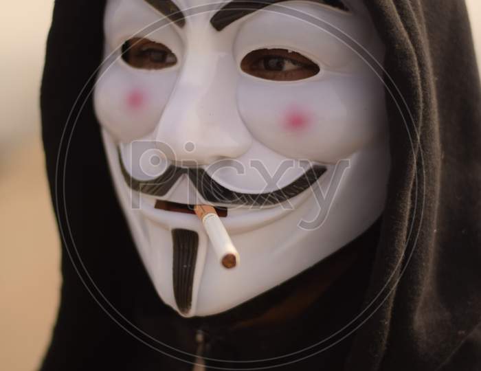 Indian Model Wearing anonymous mask smoking cigarette