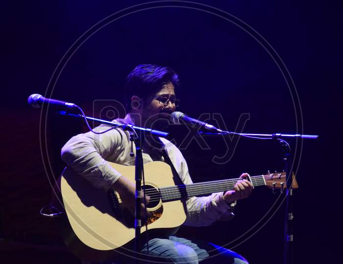 A Guitarist Singing And Performing on Stage At a College Event or Live In Concert
