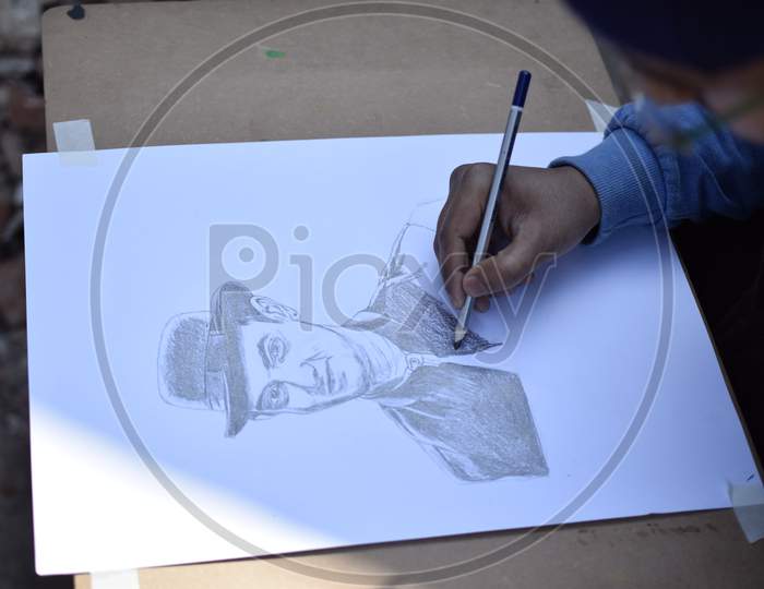 A School student drawing a man's portrait wearing a hat
