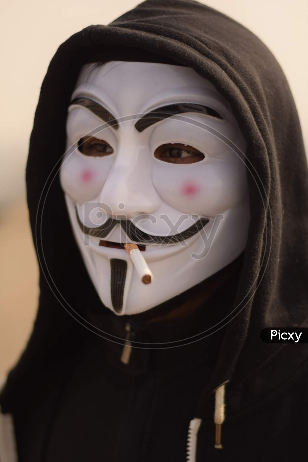 Indian Model Wearing anonymous mask smoking cigarette