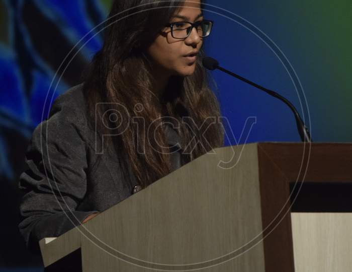 Indian girl student speaking at the podium