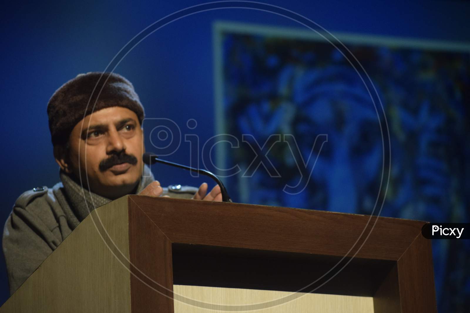 Indian Man speaking at the podium