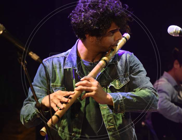 A Flutist Performing on Stage At an Live Concert Or College Event