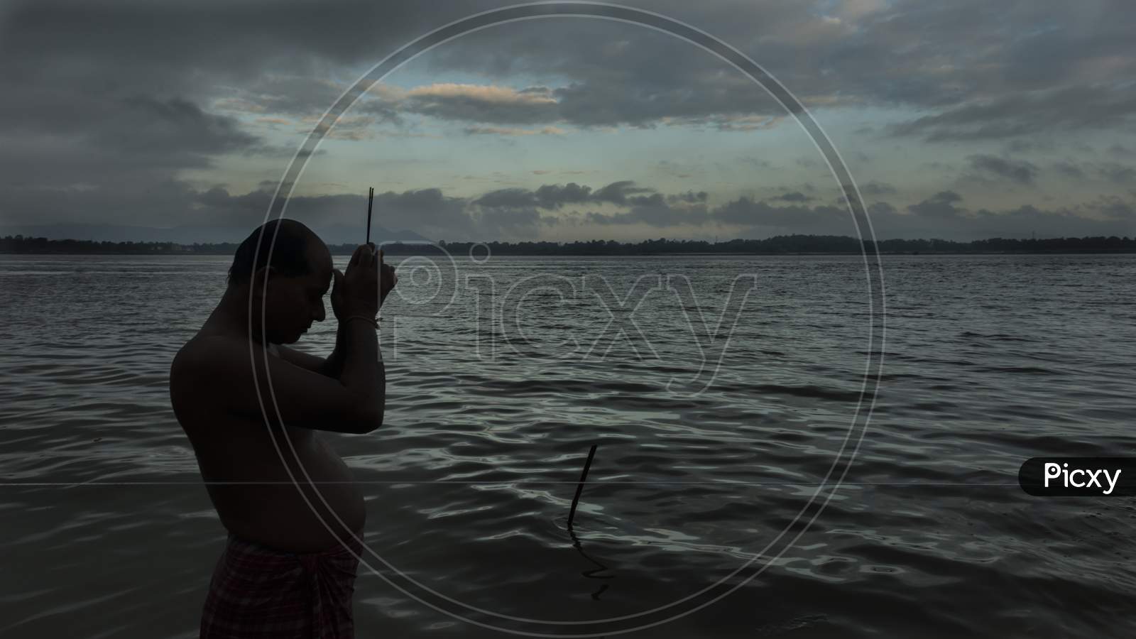 A man prays in Brahmaputra River in the early hours of a day in Guwahati, Assam.