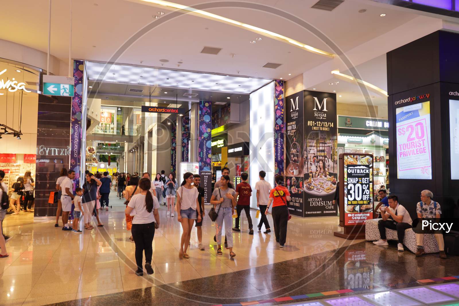 A Busy Shopping Mall With Shoppers In Singapore