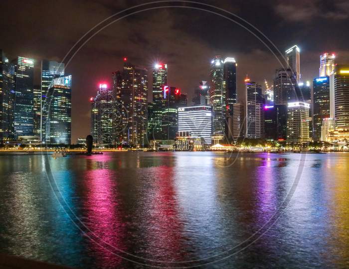 View of Marina Bay Sands With Corporate Buildings In Night Lights At Marina Bay , Singapore