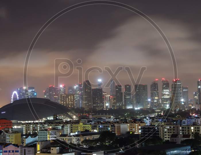 Singapore City Scape With High Rise Buildings And Apartments  In night Lights Background