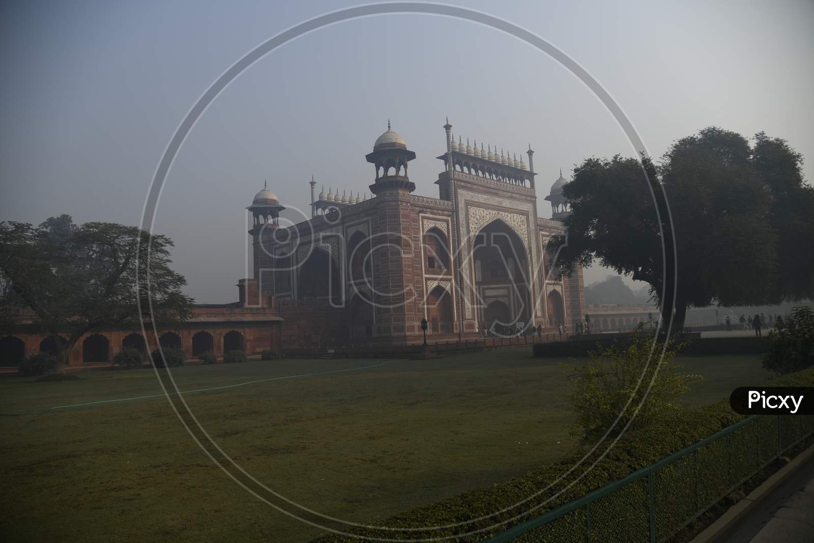 Morning view of Darwaza-i-rauza of Taj Mahal with fog