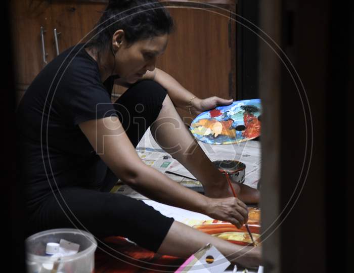 Indian woman painting using canvas