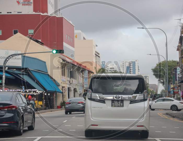 Commuting Vehicles At a Traffic Signal In Singapore City