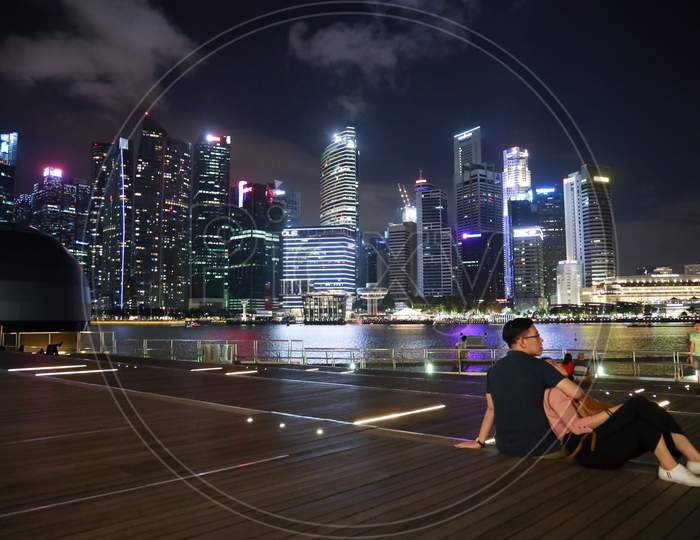 A Couple Enjoying The View Of Marina Bay Sands, Singapore