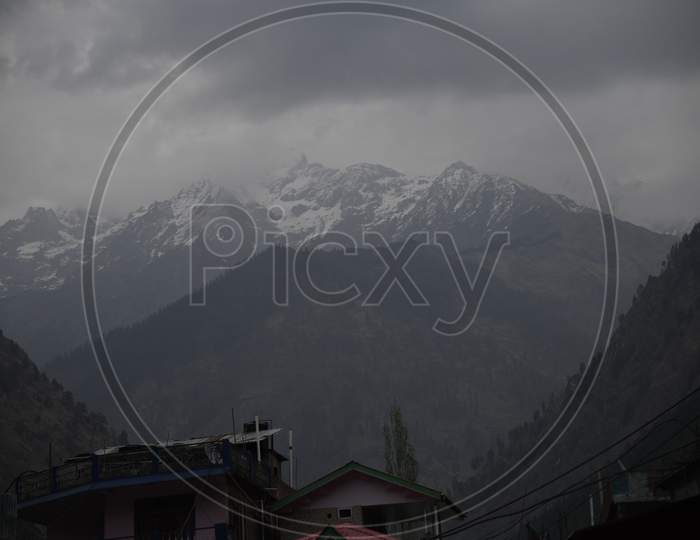 View of mountains covered with dark clouds