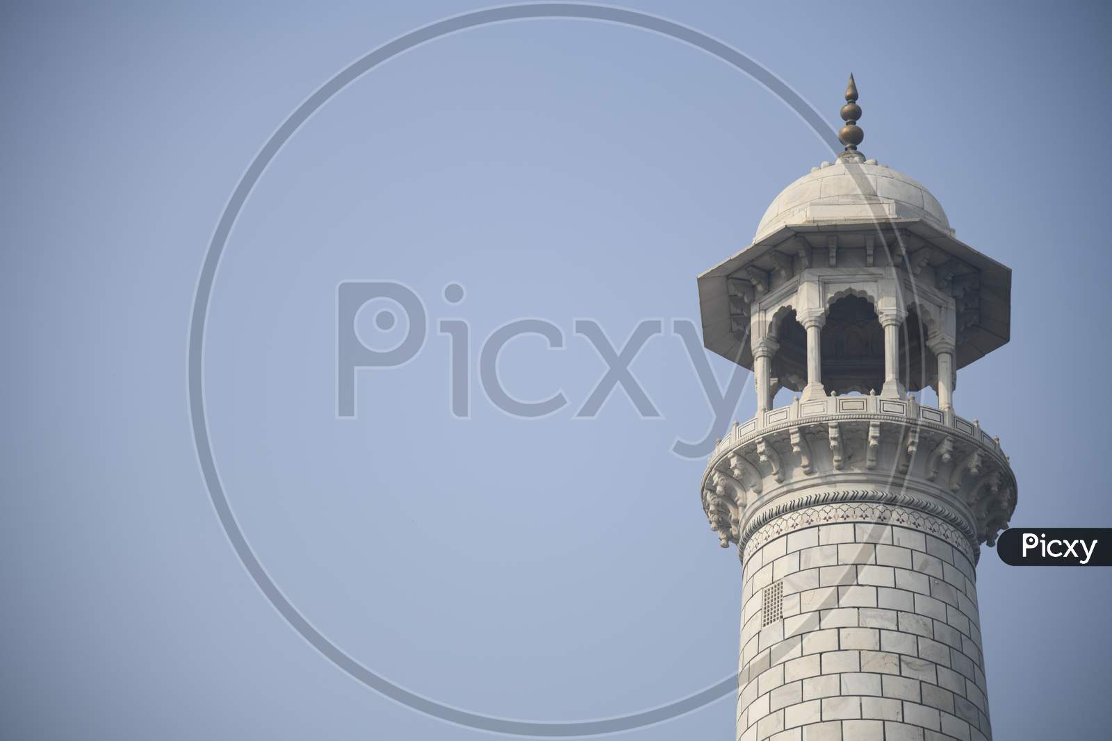 A Marble Minaret of Taj Mahal with blue sky