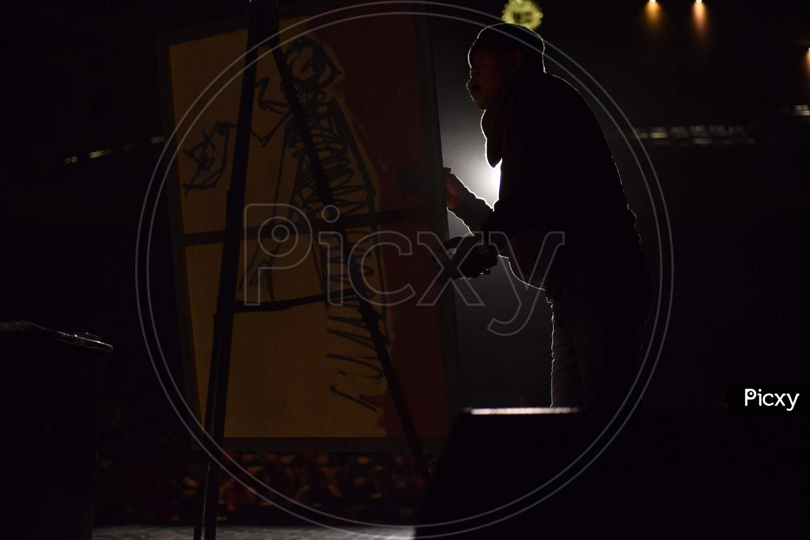 An artist sketching abstract painting on the stage