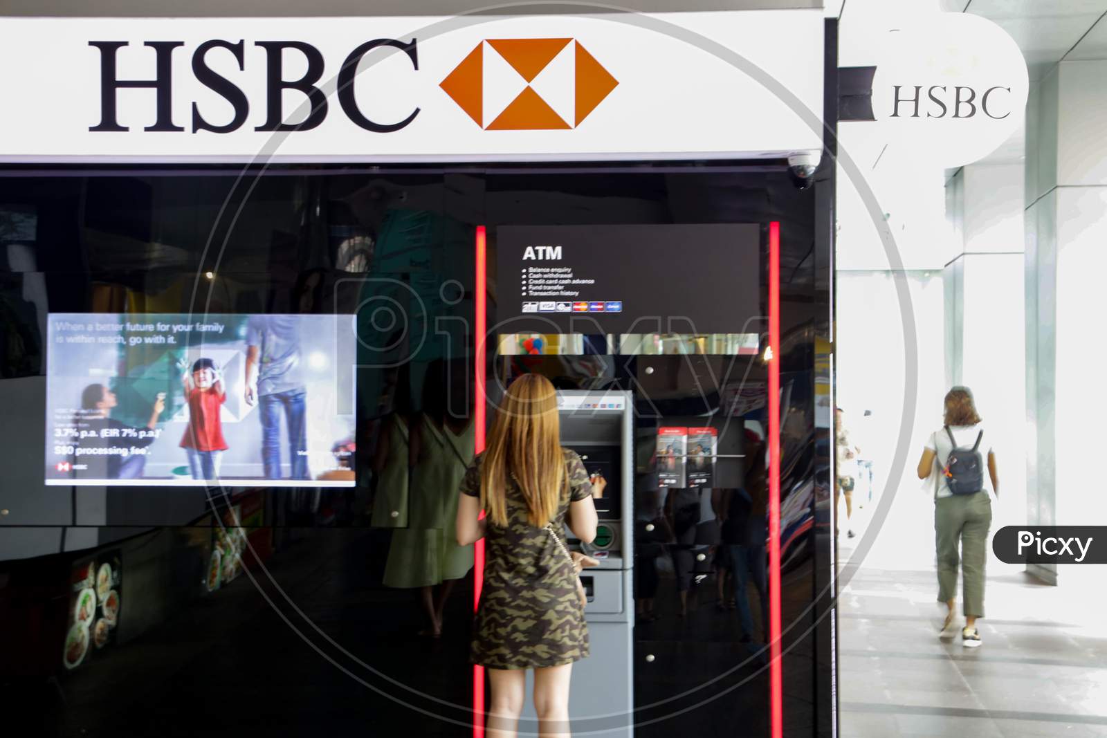 HSBC Bank ATM With A Woman Using The ATM Machine